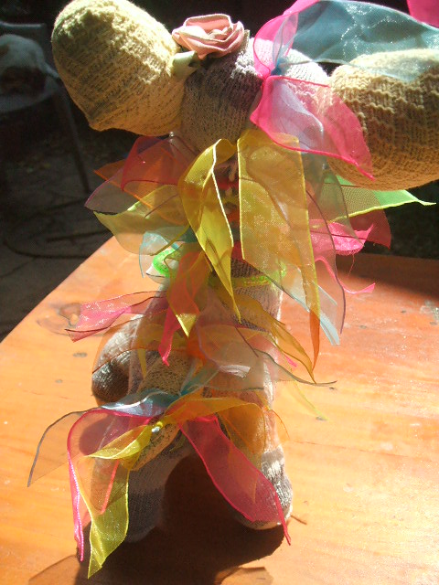 I used part of a kid's dress-up boa to put ribbons down her back, back, back... :-)
